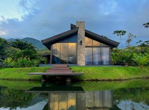 a house on an island in the water at Casa del Lago in Bijagua