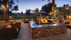 a fire pit in a patio with some tables and chairs at Marriott's Shadow Ridge II The Enclaves Studio Apartment with Resort Access in Palm Desert