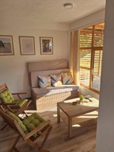 a living room with a couch and a table at Vikendica Trenutak - Vikendica na Drini in Loznica