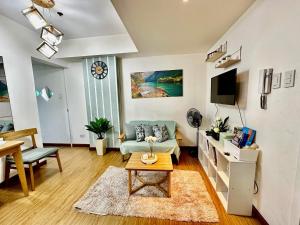 a living room with a couch and a table at Leisure Escape Azure in Sampong
