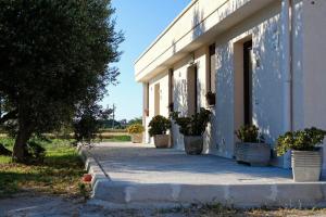 a building with potted plants on the side of it at b&b DA GINO in Lecce