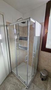a glass shower stall in a bathroom with a bucket at b&b DA GINO in Lecce +28 photos