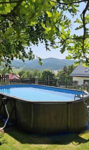 a large swimming pool with a fence around it at Willa OdNova in Tylicz
