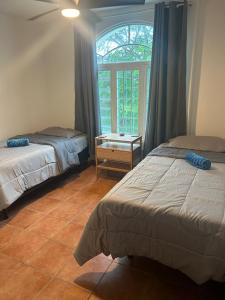 a bedroom with two beds and a window at The Yellow House: Fully Equipped, Spectacular Beach View in Manati +22 photos