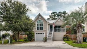 a house with a white garage at Year-Round Pool & Backyard Near Tybee Island in Savannah