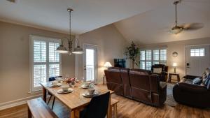 a living room with a table and a couch at Year-Round Pool & Backyard Near Tybee Island in Savannah