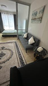 a living room with a couch and a rug at D Condo phuket kathu- patong in Amphoe Kathu