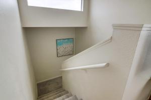 a white staircase with a window and a stair case at Beryl Bungalow in San Diego