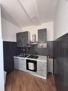 a kitchen with a sink and a stove top oven at Villa Rosaria in Giarre