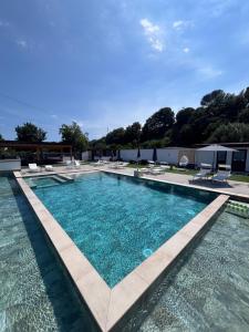 a large swimming pool with blue water in a yard at Villa Rosaria in Giarre
