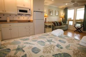 a kitchen and living room with a bed in a room at 527 Sunsuite in Fripp Island