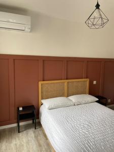 a bedroom with a bed and a nightstand next to it at Les Halles d'Isa et Thomas in Narbonne