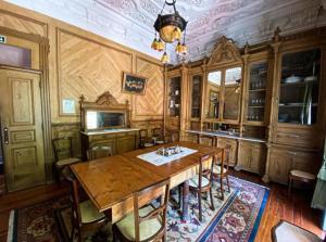 a large kitchen with a wooden table and chairs at Quinta da Capela in Viana do Castelo