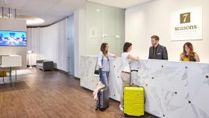 a group of people standing in an office with luggage at 7Seasons Apartments Budapest in Budapest