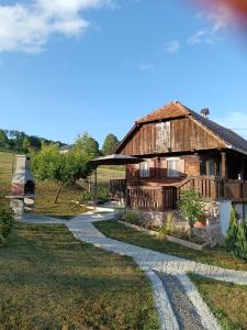 a house with a stone path leading to it at Galoma Korana in Gornji Velemerić