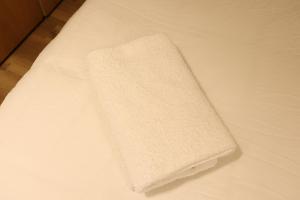 a white blanket sitting on top of a bed at Lotus Suite 42 in Eilat