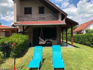 two blue chairs in the yard of a house at Mária Villa in Balatonmáriafürdő +21 photos
