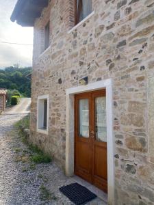 a stone building with a wooden door on it at La Casetta in Costa in Marostica +20 photos