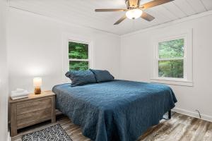 a bedroom with a bed and a ceiling fan at Spacious 3 Bedroom on Arbutus Lake in Traverse City