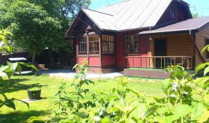 a small wooden house with a porch and a yard at Mover mount apart in Skole +52 photos