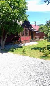 a small building with a tree in front of it at Mover mount apart in Skole