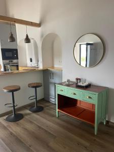 una cucina con una cassettiera verde e uno specchio di Pátio do Forno a Mértola