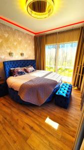 a bedroom with a bed and a large window at Župė Dream House with jacuzzi and sauna in Klaipėda