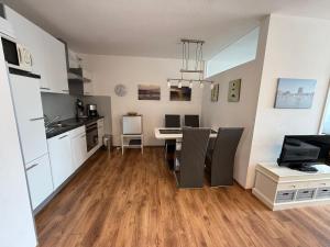 a kitchen and dining room with a table and chairs at Panorama Whg 42, 2 OG in Cuxhaven