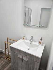 a bathroom with a white sink and a mirror at Ericeira Ribamar Sea View Villa in Santo Isidoro +28 photos