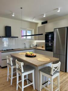 a kitchen with a table with a bowl of fruit on it at Alley Apartment in Lefkada Town