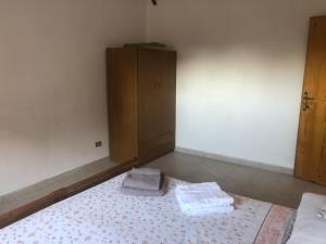 a bedroom with a bed with two towels on it at Casa Emilia in Ginosa Marina