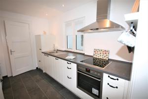 a kitchen with a sink and a stove at Brise 5 in Büsum