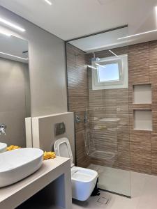a bathroom with a shower and a sink and a toilet at Alley Apartment in Lefkada Town +35 photos