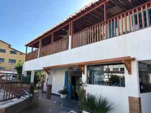 a large building with a balcony on top of it at Pousada Mar E Mata in Guarapari