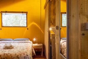 a bedroom with a bed and a yellow wall at Refúgio da Cigarra in Tomar +56 photos