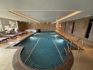 a large swimming pool in a hotel lobby at Peninsula Apartment 2 in St Ives