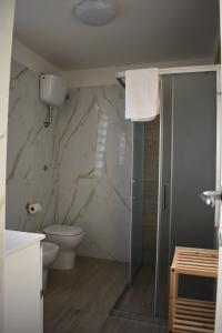 a bathroom with a toilet and a shower stall at VillART Pompei Guest House in Pompei