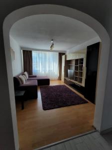 a living room with a couch and a table at Central Residence in Piatra Neamţ