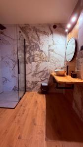 a bathroom with a counter and a sink and a shower at Apartamenty Tatry in Male Ciche