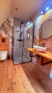 a bathroom with a shower and a wooden table at Apartamenty Tatry in Male Ciche +21 photos