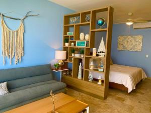 a living room with a couch and a bed at Piedra Azul in Playa del Carmen +18 photos