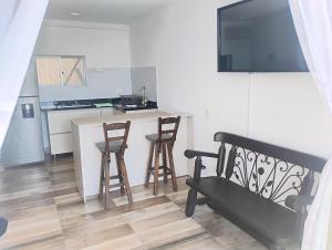 una cucina con un bancone e sgabelli in una stanza di Apartamento en Ricaurte Cundinamarca a Ricaurte
