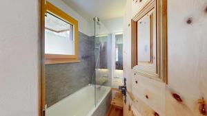 a bathroom with a shower and a glass shower stall at Abitaziun Chüderas 12 in La Punt-Chamues-ch +25 photos