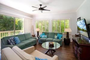 a living room with a couch and a flat screen tv at Regency 311 in Kipu