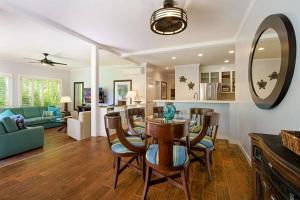 a dining room and living room with a table and chairs at Regency 311 in Kipu