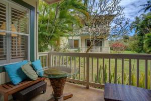 a porch with a glass table and a chair at Regency 311 in Kipu