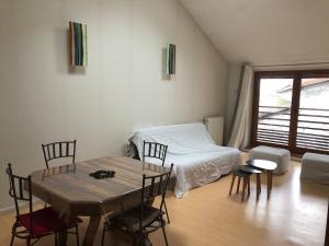 una stanza con un letto, un tavolo e delle sedie di LaForge a Noyarey