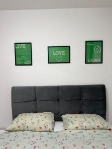 a black bed with three pictures on the wall at Nur Bulevar in Sarajevo