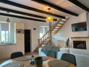 a living room with a couch and a table at Casă chic La Han la Slănic in Slănic-Moldova