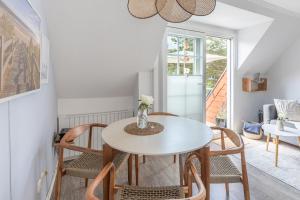 a dining room with a white table and chairs at Wellenklang in Böhl